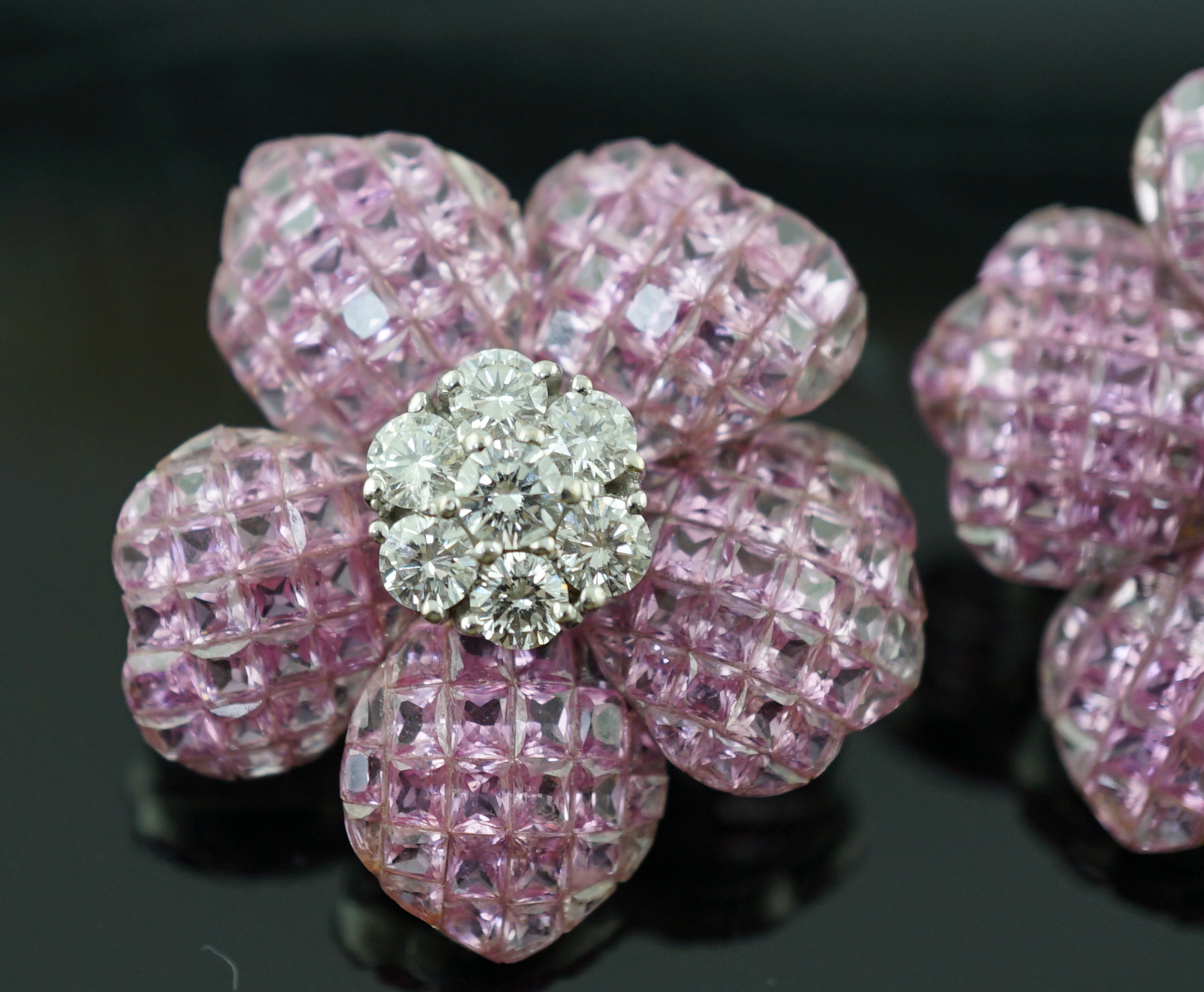 A pair of 18k white gold, pink sapphire and diamond cluster set flower head ear clips/earrings